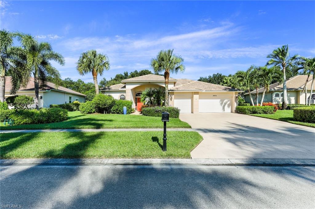 8906 Lely Island Circle Naples, FL 34113 - Photo 2 of 34 a front view of a house with a yard