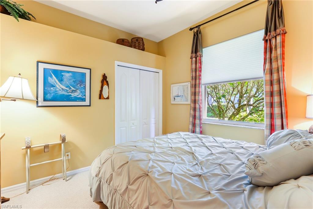 8906 Lely Island Circle Naples, FL 34113 - Photo 22 of 34 a bedroom with a bed and a window