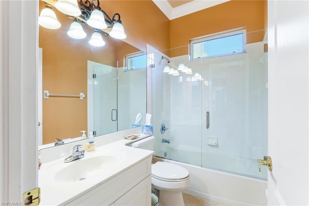 8906 Lely Island Circle Naples, FL 34113 - Photo 25 of 34 a bathroom with a sink a toilet and shower