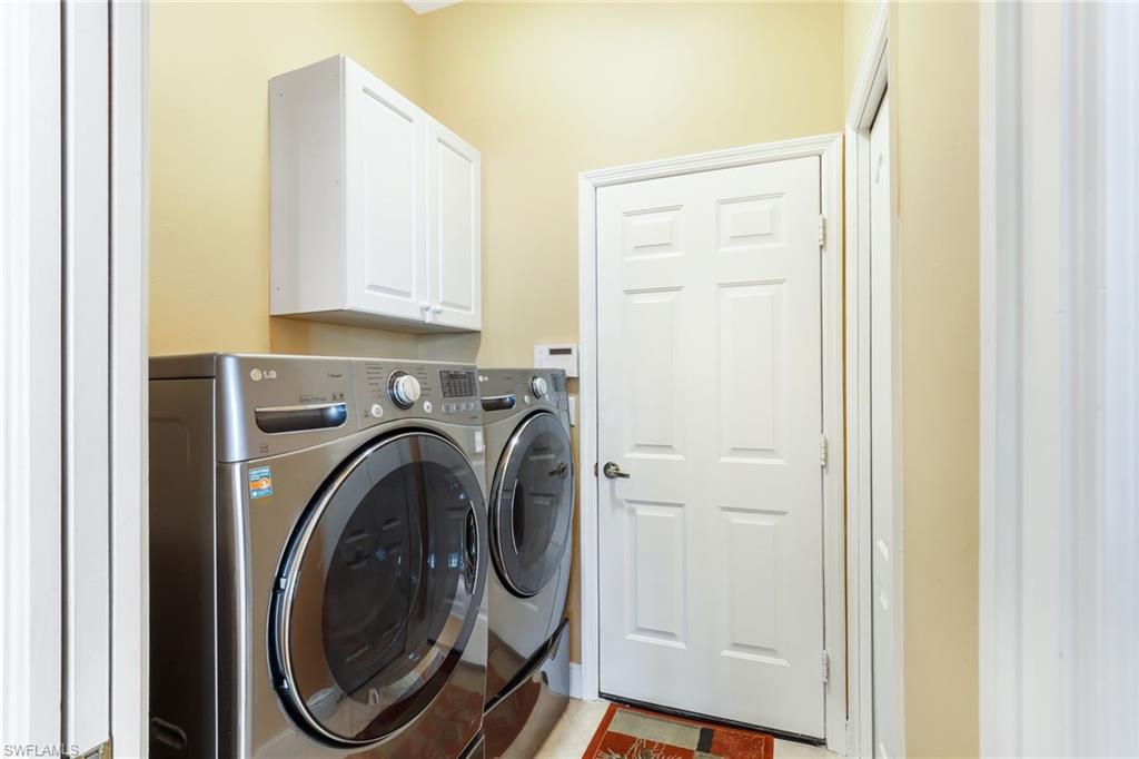 8906 Lely Island Circle Naples, FL 34113 - Photo 27 of 34 a view of a hallway with washer and dryer
