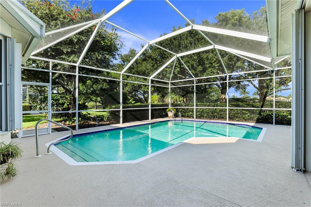 8906 Lely Island Circle Naples, FL 34113 - Photo 29 of 34 a view of a backyard with a swimming pool