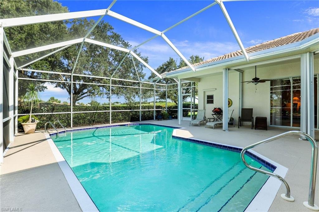 8906 Lely Island Circle Naples, FL 34113 - Photo 30 of 34 a view of a backyard with a swimming pool