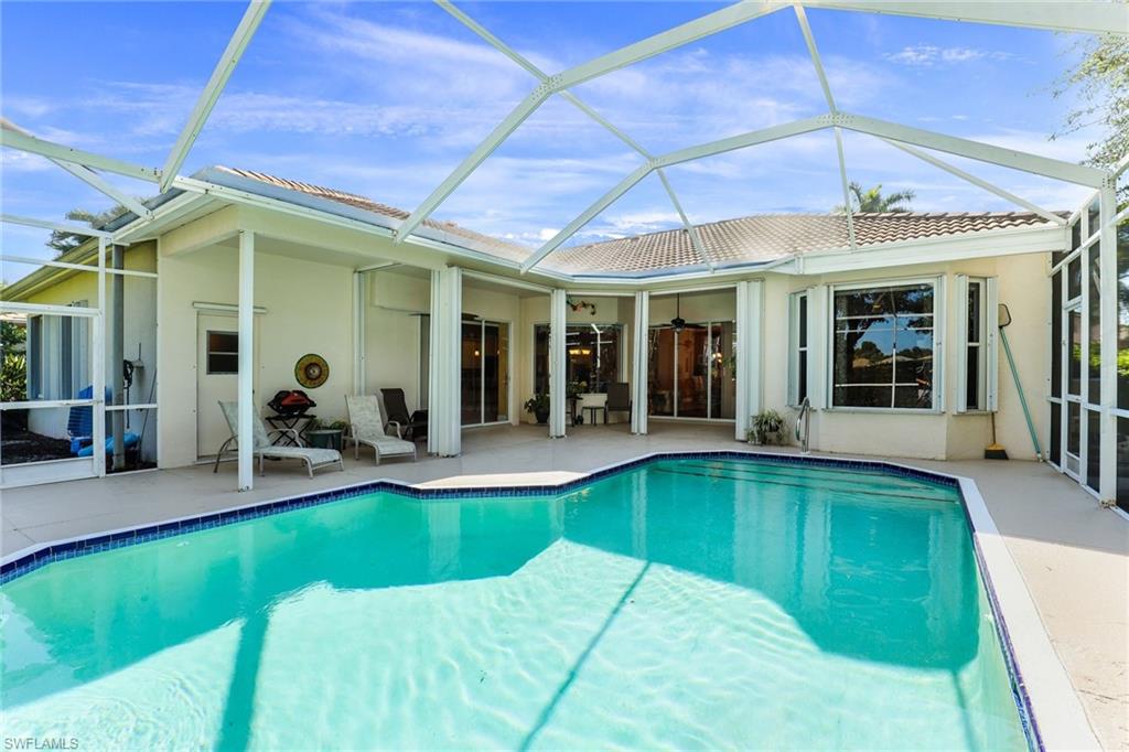 8906 Lely Island Circle Naples, FL 34113 - Photo 31 of 34 a view of a swimming pool with a patio