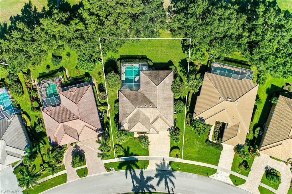 8906 Lely Island Circle Naples, FL 34113 - Photo 32 of 34 an aerial view of a house with table and chairs