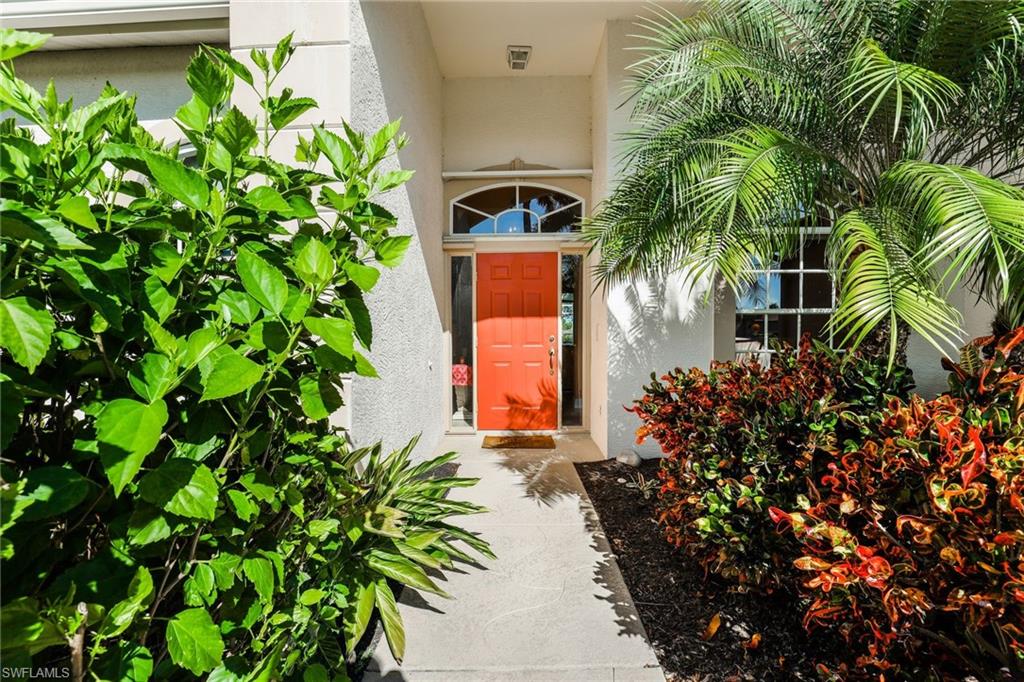 8906 Lely Island Circle Naples, FL 34113 - Photo 5 of 34 a front view of a house with a plant