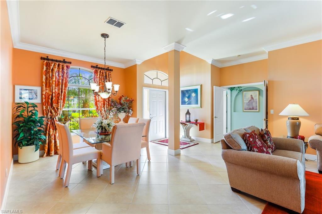8906 Lely Island Circle Naples, FL 34113 - Photo 7 of 34 a living room with furniture a lamp and a large window