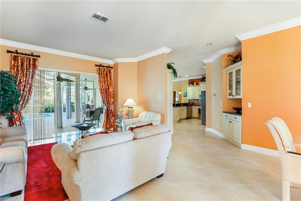 8906 Lely Island Circle Naples, FL 34113 - Photo 8 of 34 a living room with furniture and a large window