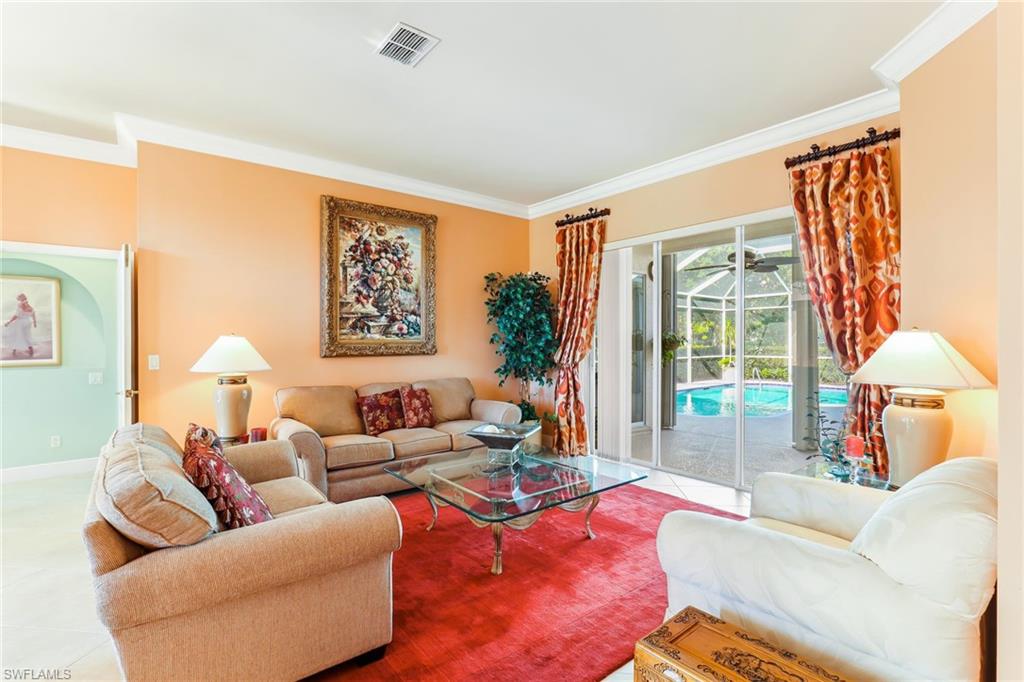 8906 Lely Island Circle Naples, FL 34113 - Photo 9 of 34 a living room with furniture and a large window