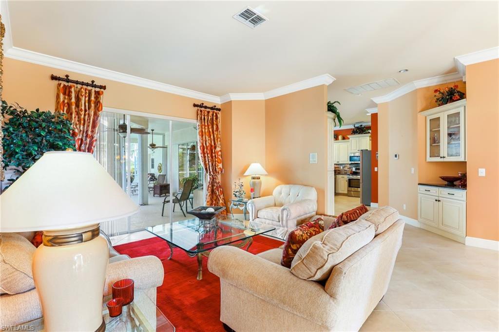 8906 Lely Island Circle Naples, FL 34113 - Photo 10 of 34 a living room filled with furniture and a large window