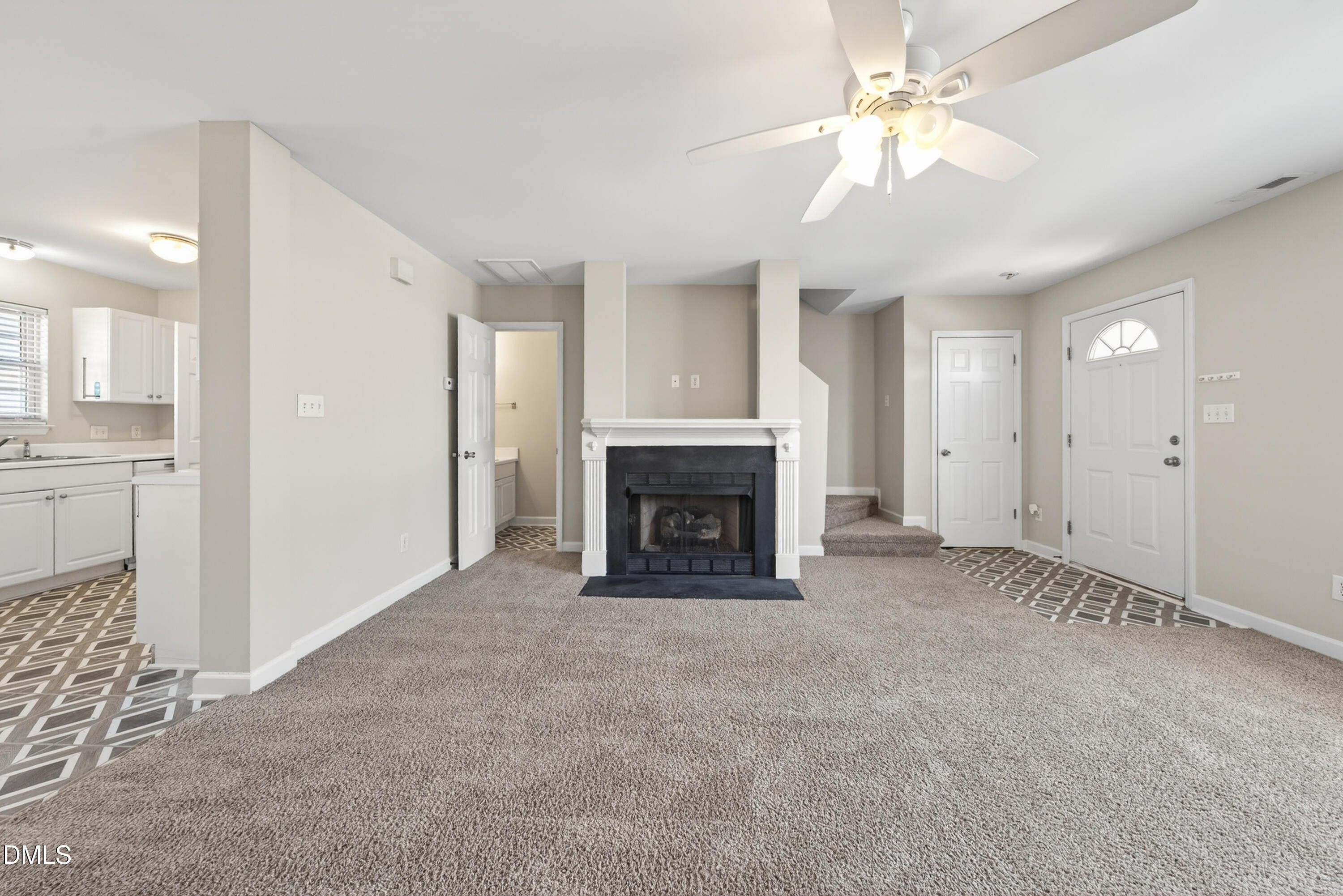 1601 Briarmont Court Raleigh, NC 27610 - Photo 10 of 30 a view of a livingroom with a fireplace and a chandelier fan