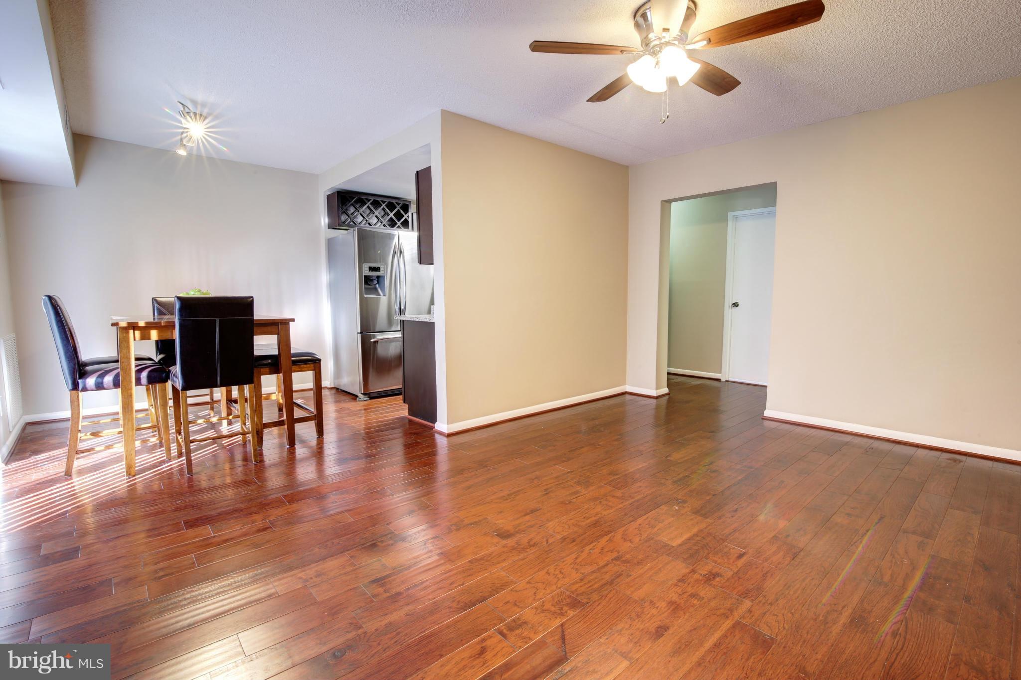 11627 Stoneview Square, Unit 11C Reston, VA 20191 - Photo 5 of 19 a view of empty room with wooden floor and ceiling fan