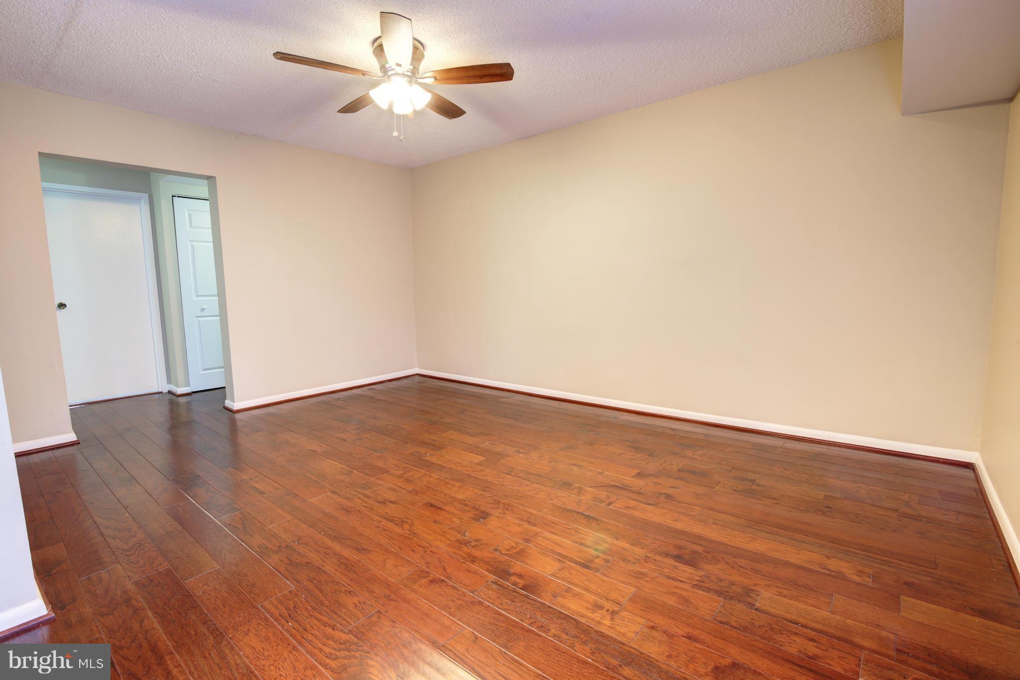 11627 Stoneview Square, Unit 11C Reston, VA 20191 - Photo 6 of 19 a view of an empty room with wooden floor
