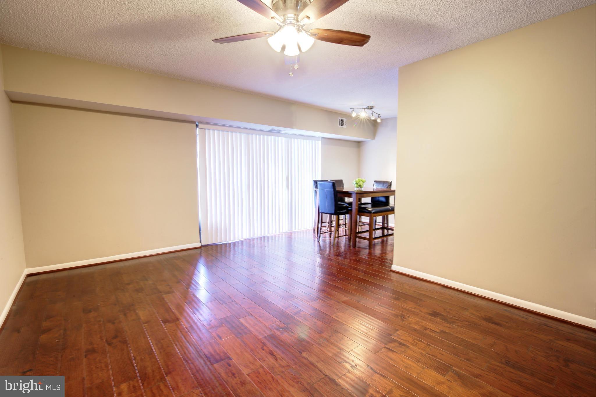 11627 Stoneview Square, Unit 11C Reston, VA 20191 - Photo 7 of 19 a view of an empty room with wooden floor