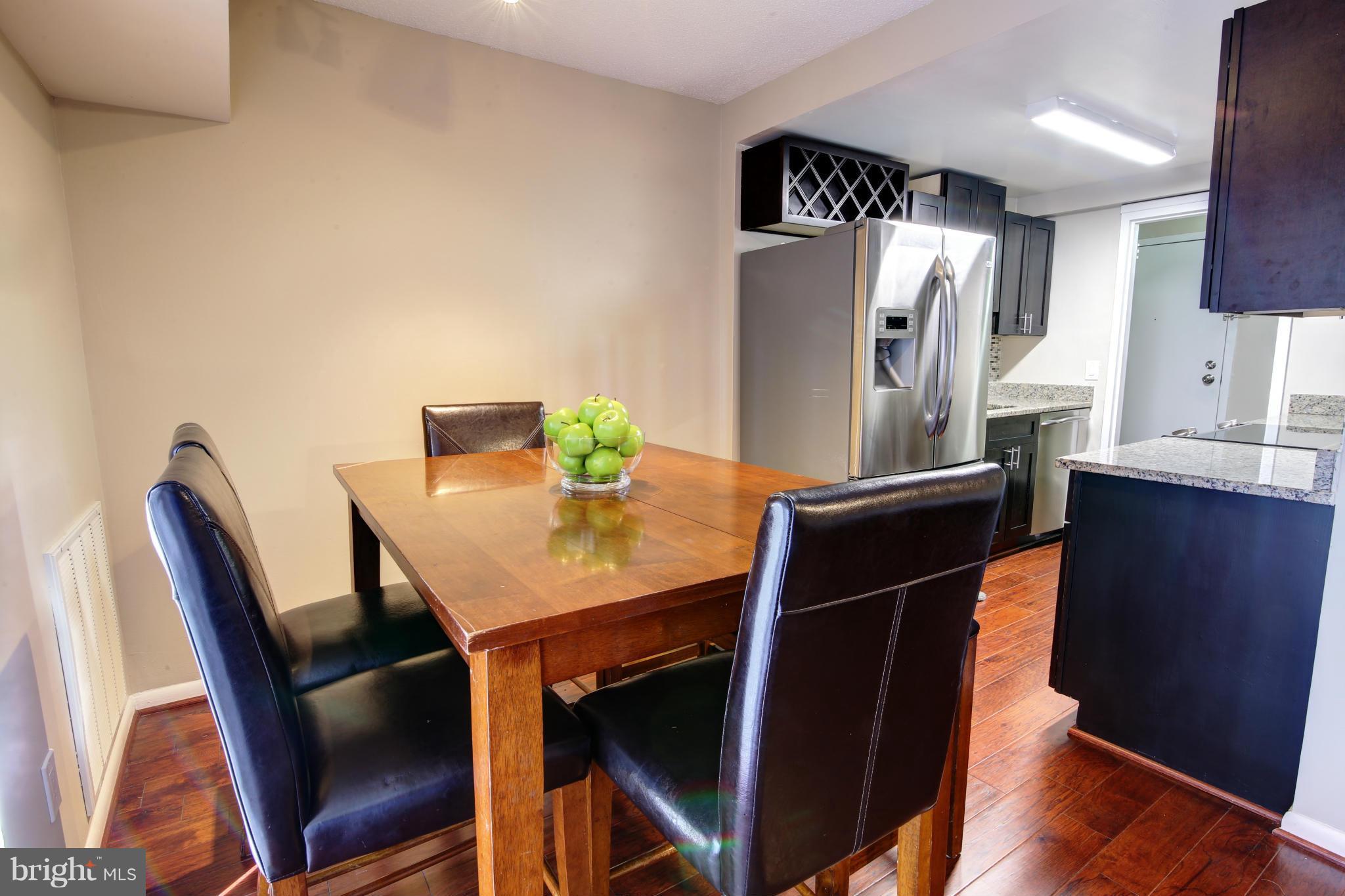 11627 Stoneview Square, Unit 11C Reston, VA 20191 - Photo 9 of 19 a view of a dining room with furniture and wooden floor
