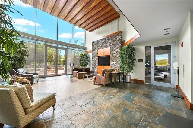 a view of a livingroom with furniture and floor to ceiling window