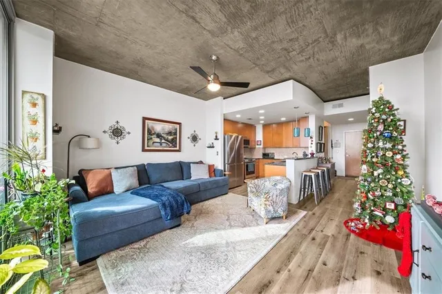 a living room with furniture flowers and a chandelier