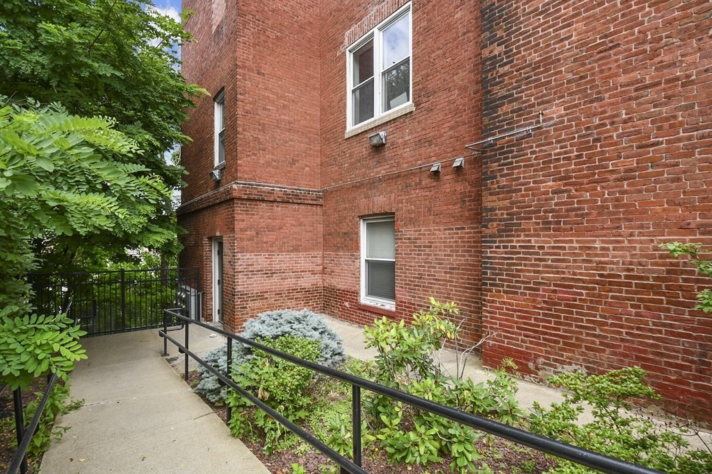 32 Providence Street, Unit 5 Worcester, MA 01604 - Photo 22 of 24 front view of a brick house with a large windows