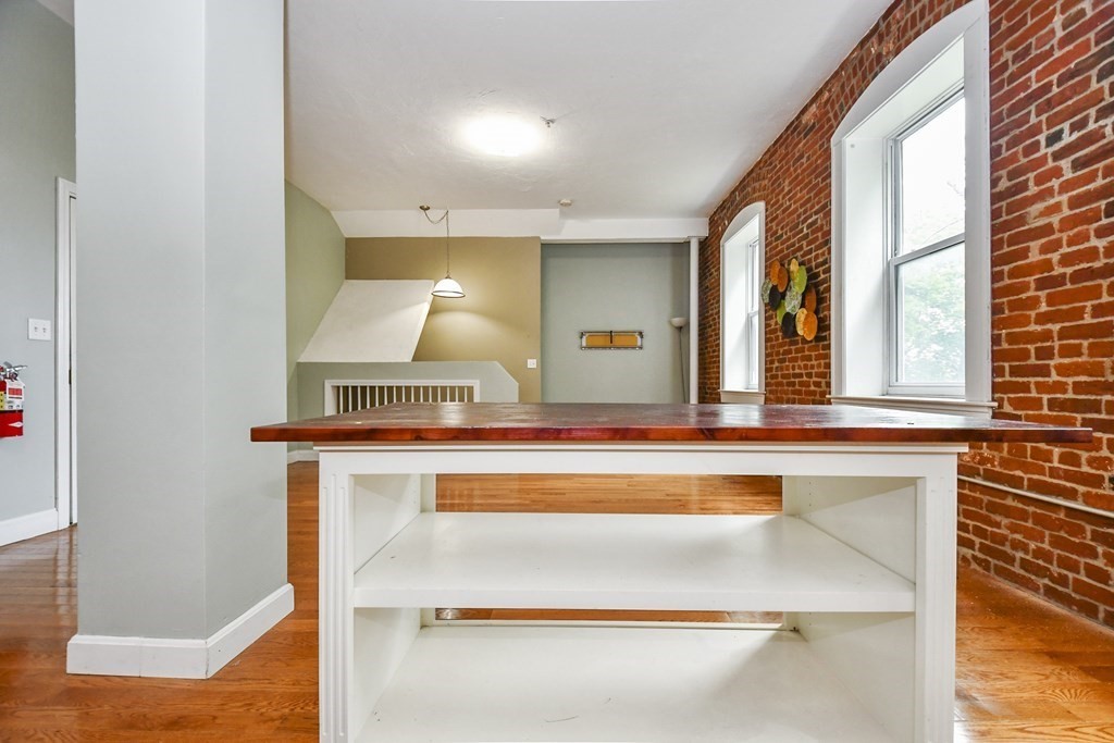 32 Providence Street, Unit 5 Worcester, MA 01604 - Photo 7 of 24 a view of kitchen with cabinets and wooden floor