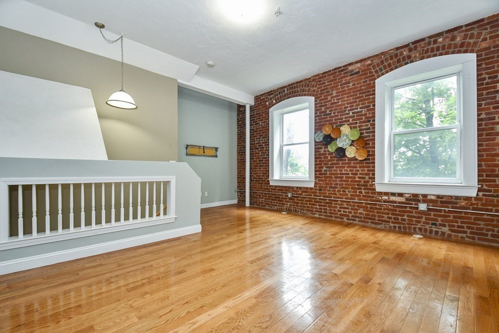 32 Providence Street, Unit 5 Worcester, MA 01604 - Photo 8 of 24 a view of an empty room with wooden floor and a window