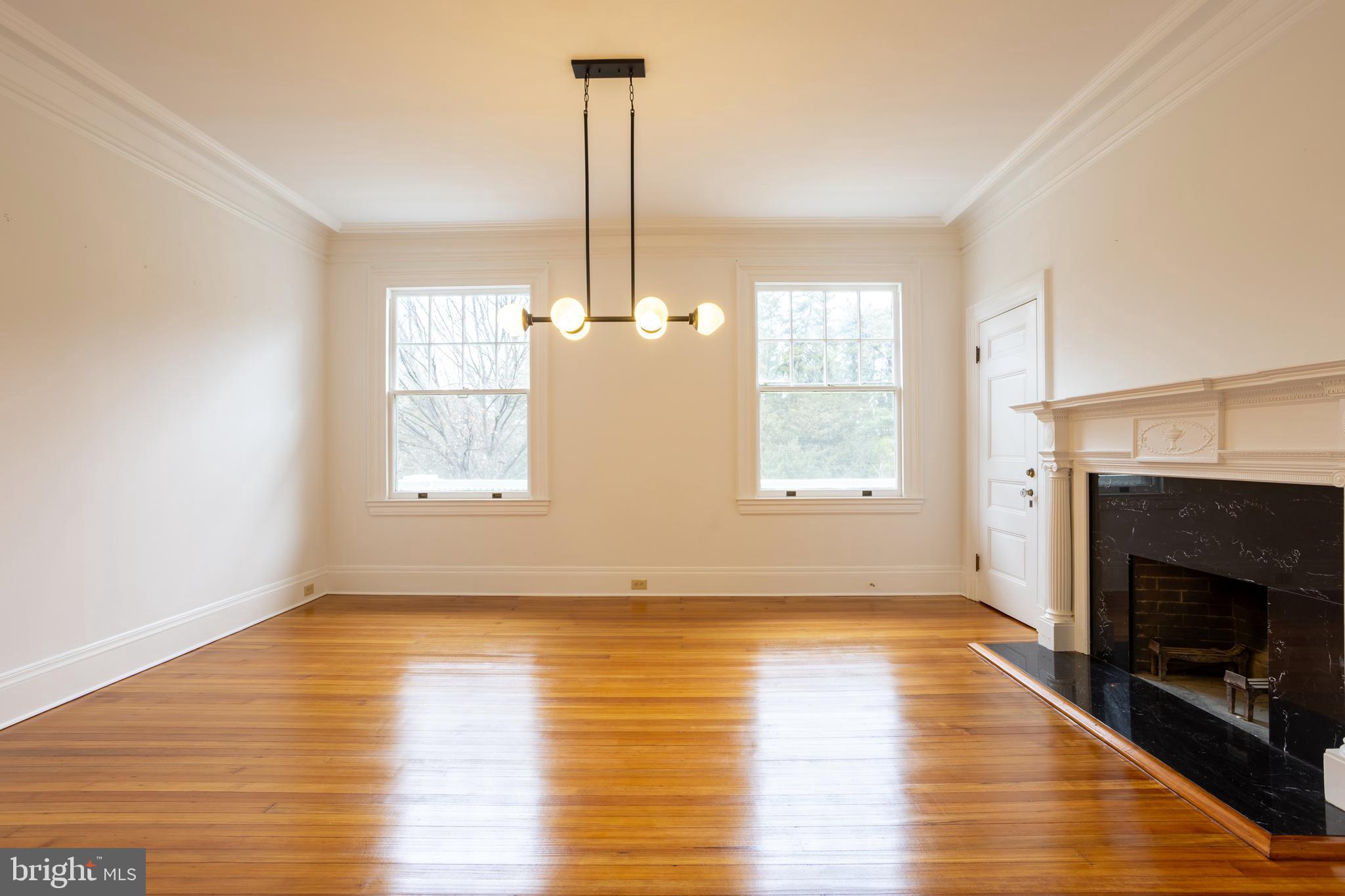3 Devon Hill Road, Unit D4 Baltimore, MD 21210 - Photo 11 of 46 a view of an empty room with wooden floor fireplace and a window