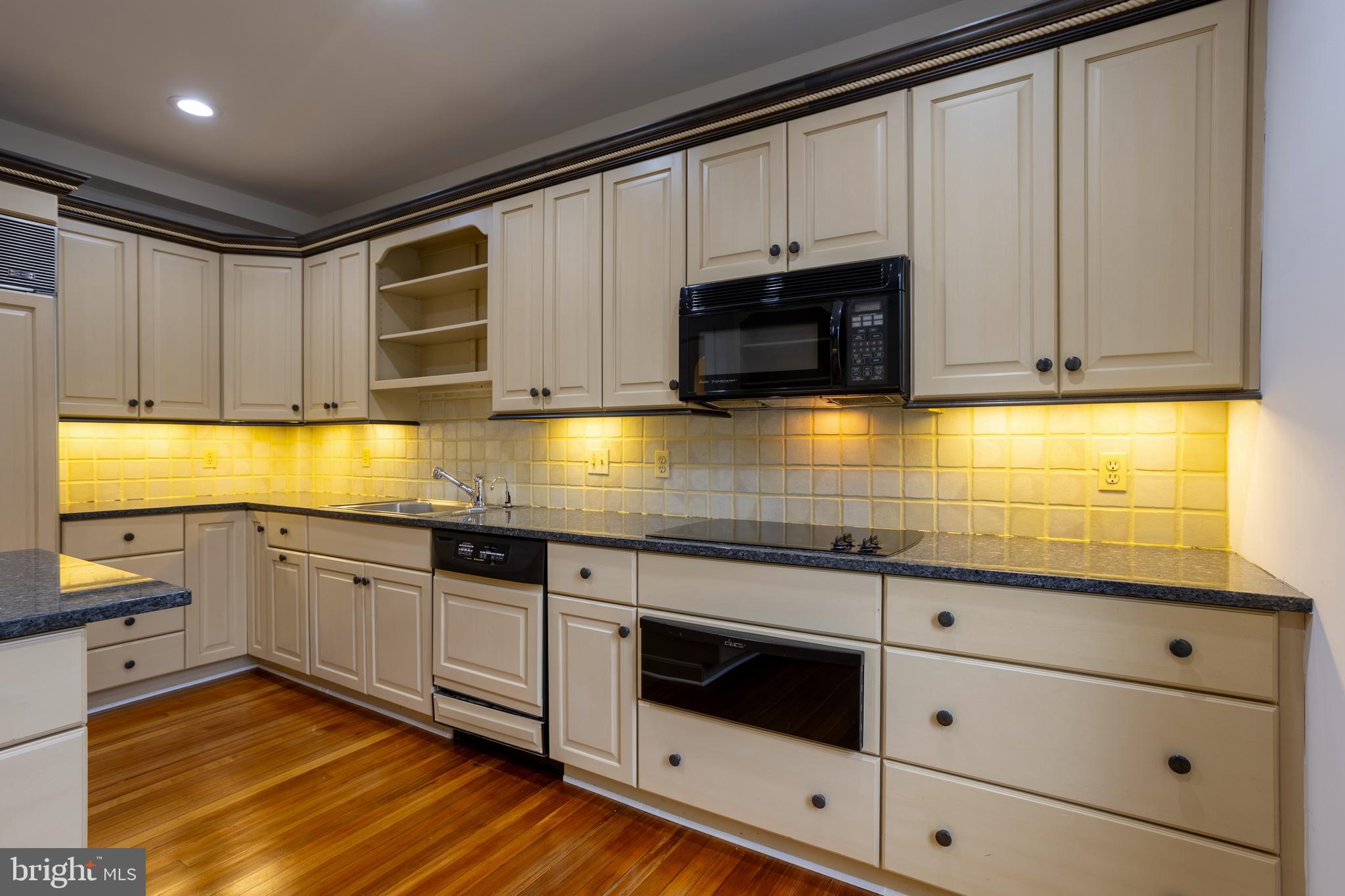 3 Devon Hill Road, Unit D4 Baltimore, MD 21210 - Photo 13 of 46 a kitchen with granite countertop cabinets stainless steel appliances and a sink