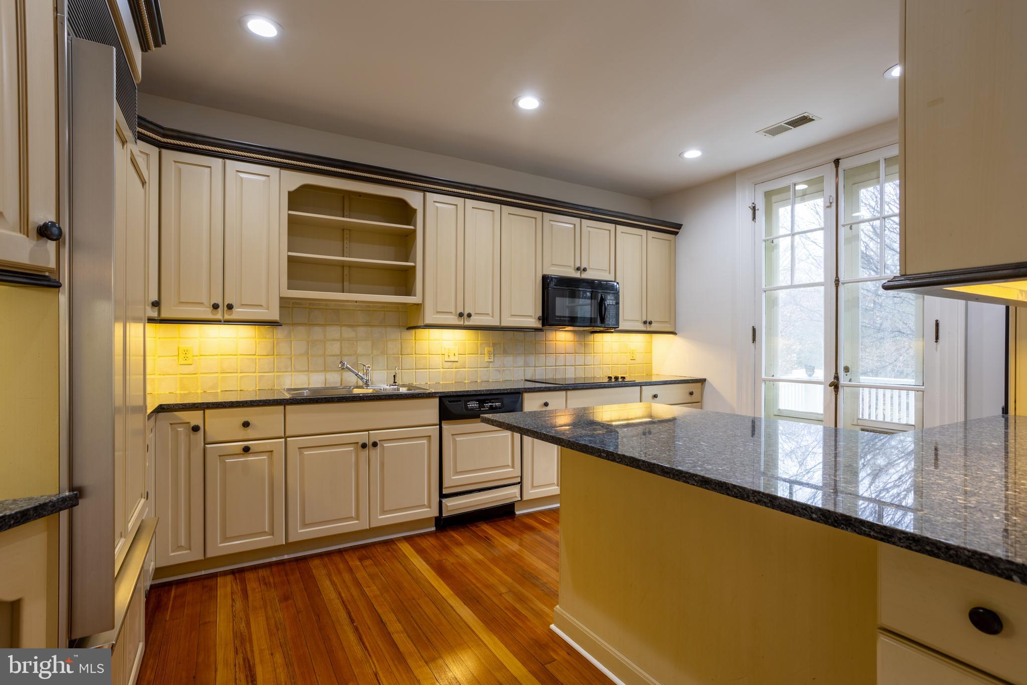 3 Devon Hill Road, Unit D4 Baltimore, MD 21210 - Photo 14 of 46 a kitchen with stainless steel appliances granite countertop a sink stove and cabinets