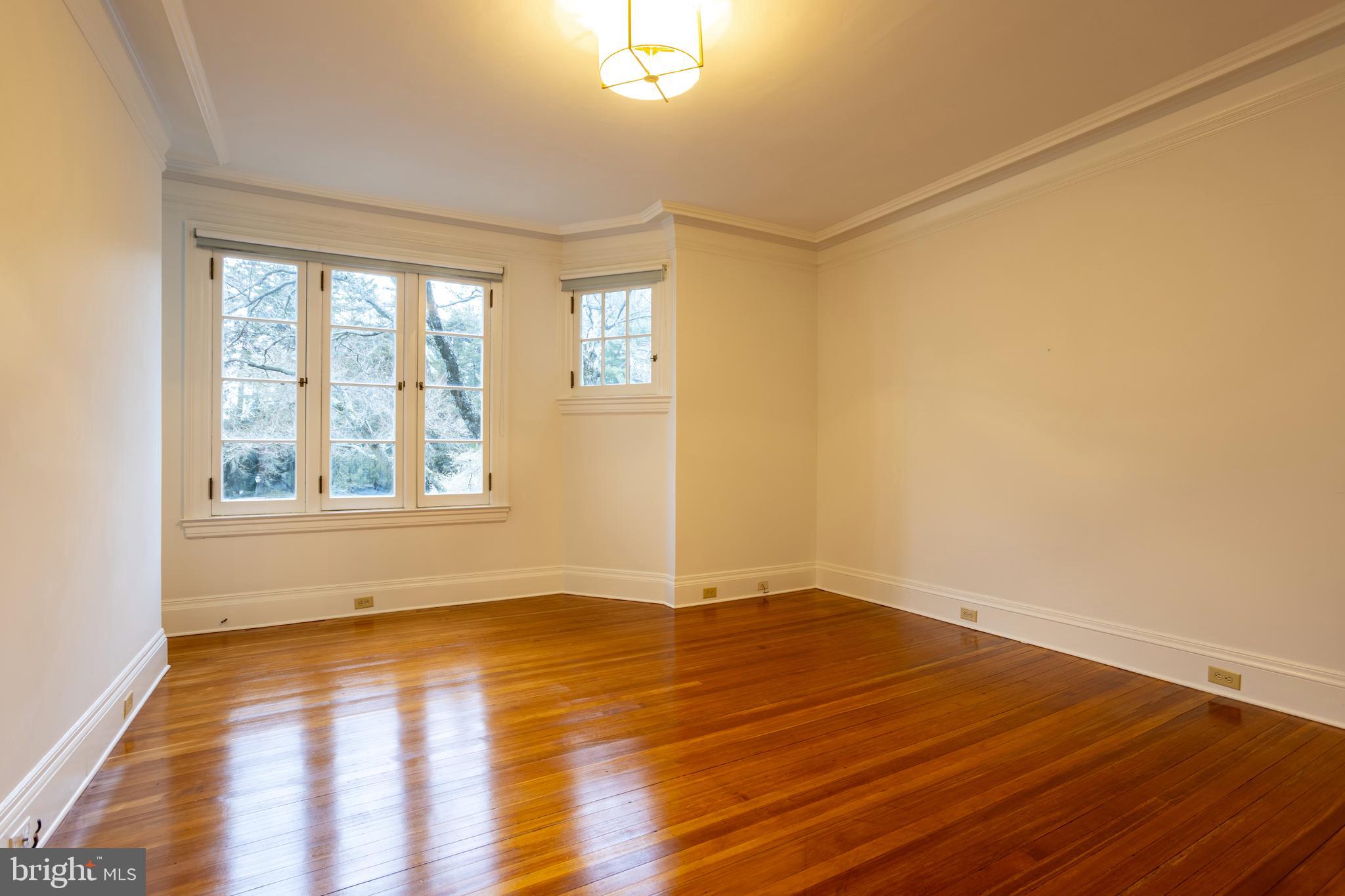 3 Devon Hill Road, Unit D4 Baltimore, MD 21210 - Photo 23 of 46 a view of an empty room with wooden floor and a window