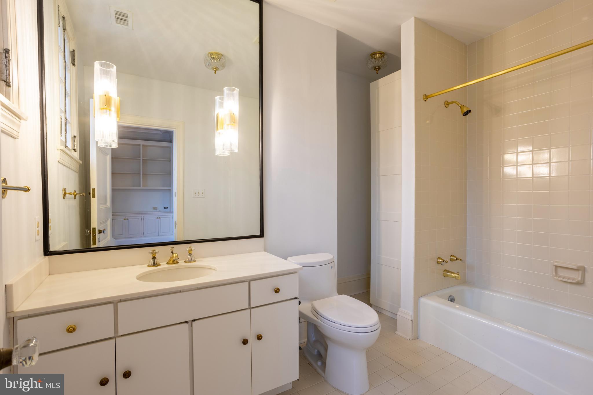 3 Devon Hill Road, Unit D4 Baltimore, MD 21210 - Photo 29 of 46 a bathroom with a bathtub shower sink vanity and toilet