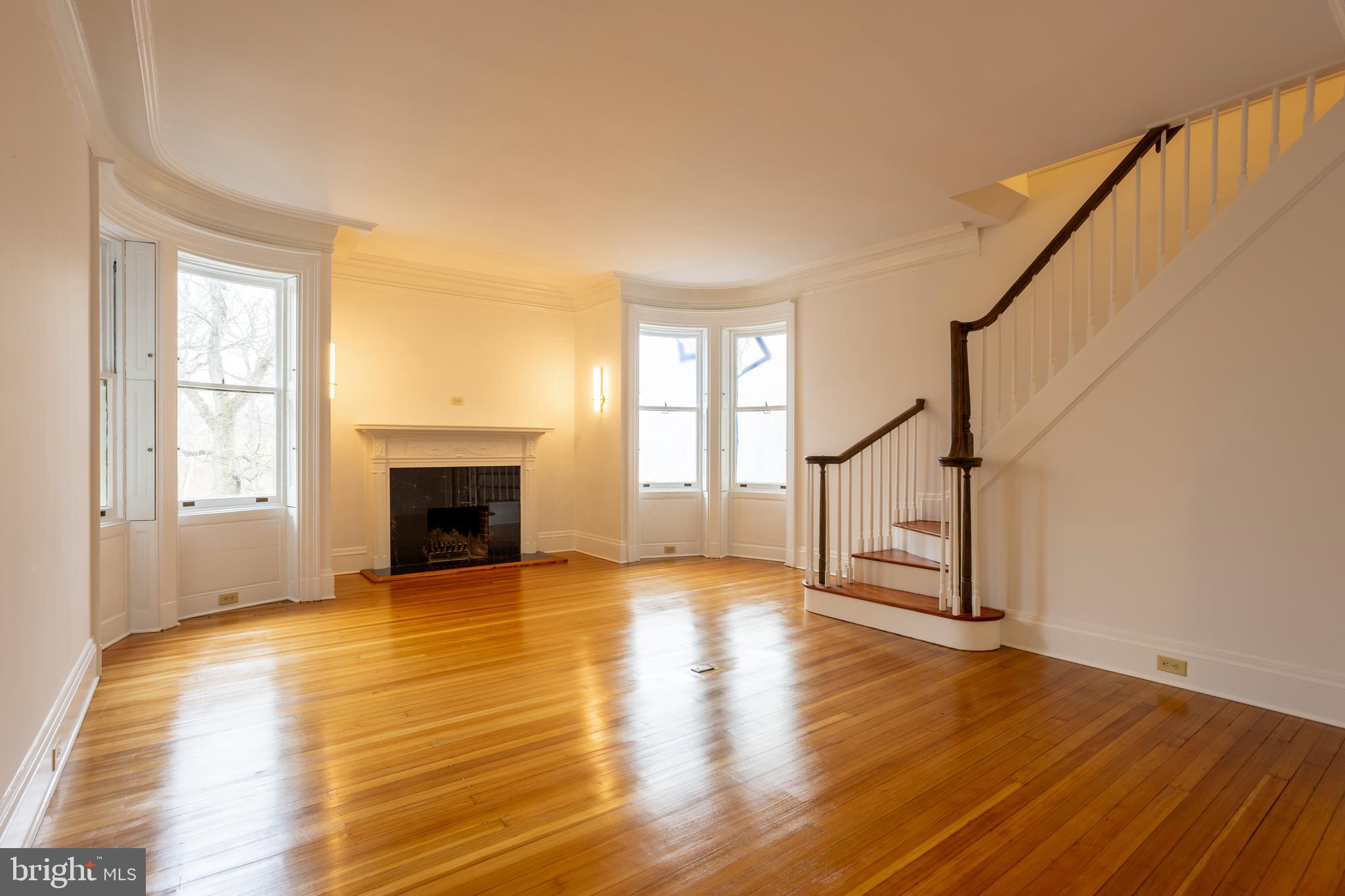3 Devon Hill Road, Unit D4 Baltimore, MD 21210 - Photo 7 of 46 a view of empty room with fireplace and wooden floor