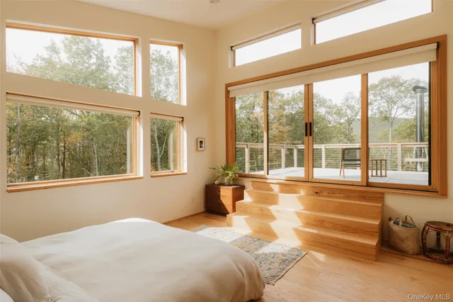 a bedroom with a bed and glass windows