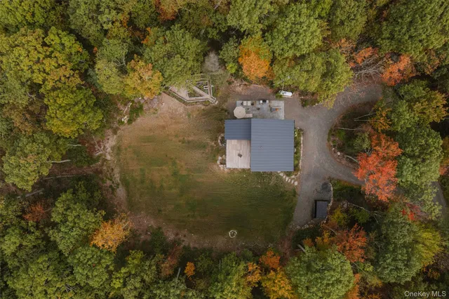a bed with white sheets and pillows on it