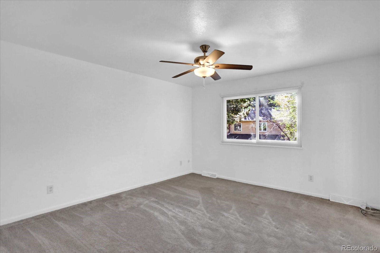 3754 South Walden Way Aurora, CO 80013 - Photo 13 of 32 an empty room with windows and fan