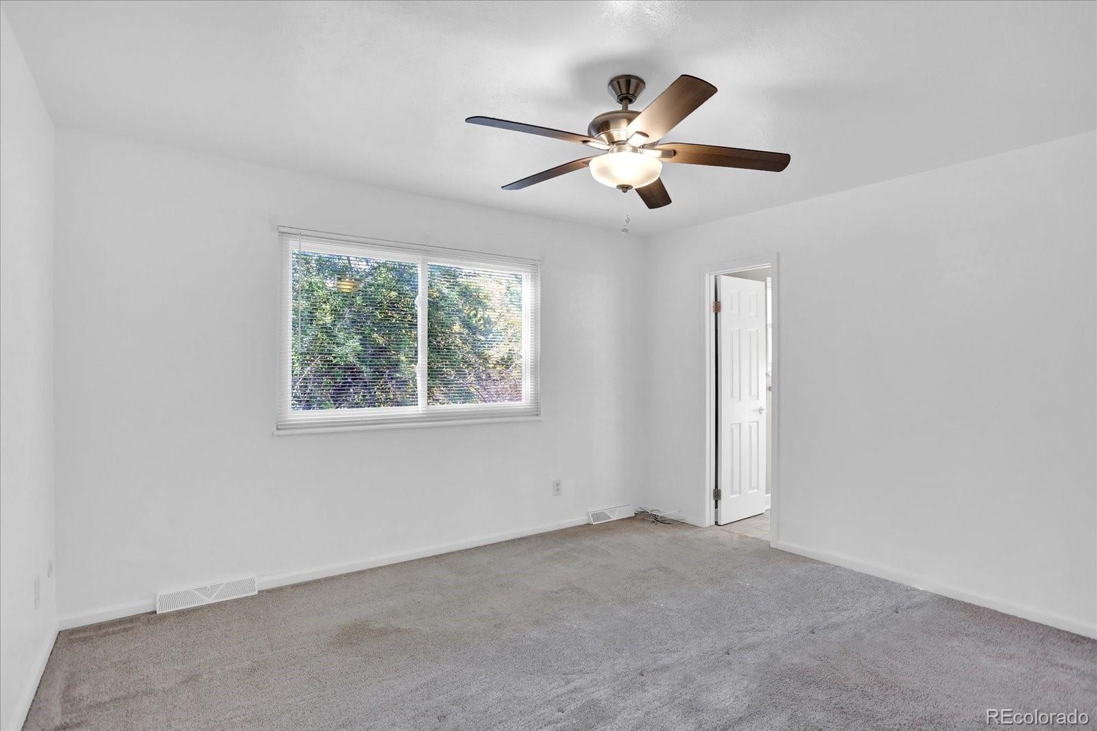 3754 South Walden Way Aurora, CO 80013 - Photo 14 of 32 an empty room with windows and fan