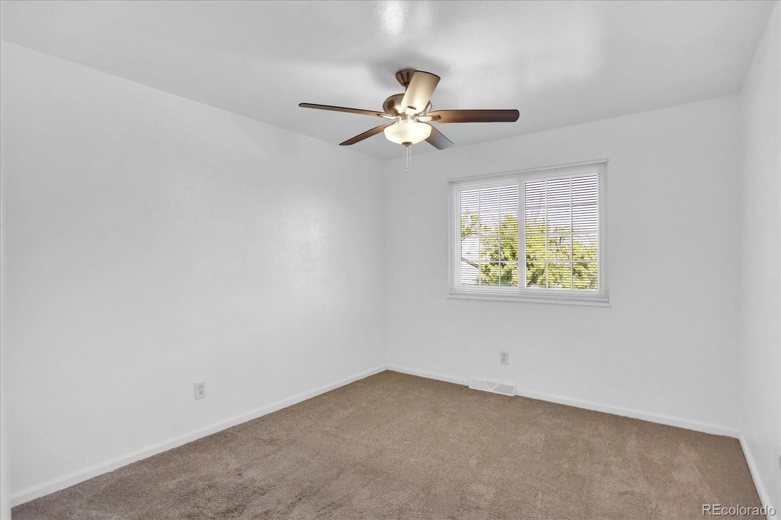 3754 South Walden Way Aurora, CO 80013 - Photo 17 of 32 an empty room with a window and ceiling fan