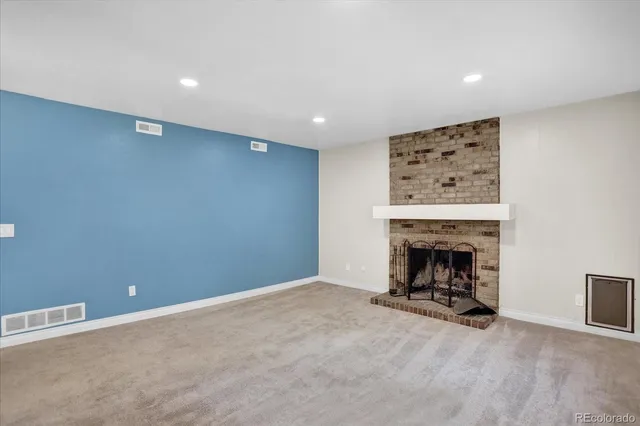 an empty room with a fireplace