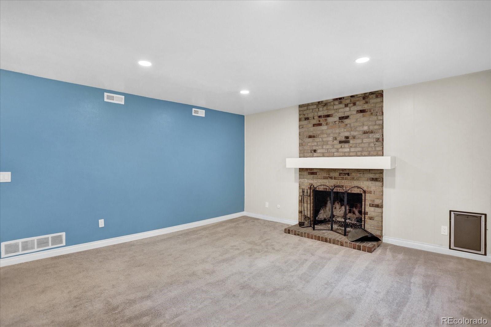 3754 South Walden Way Aurora, CO 80013 - Photo 21 of 32 an empty room with a fireplace