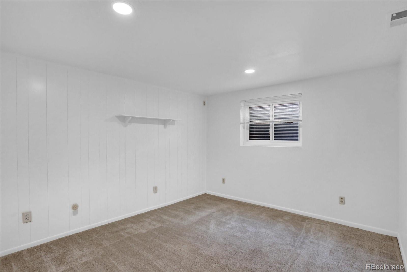 3754 South Walden Way Aurora, CO 80013 - Photo 24 of 32 an empty room with a empty space and windows
