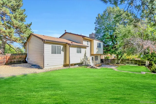 a view of a house with a yard and sitting area