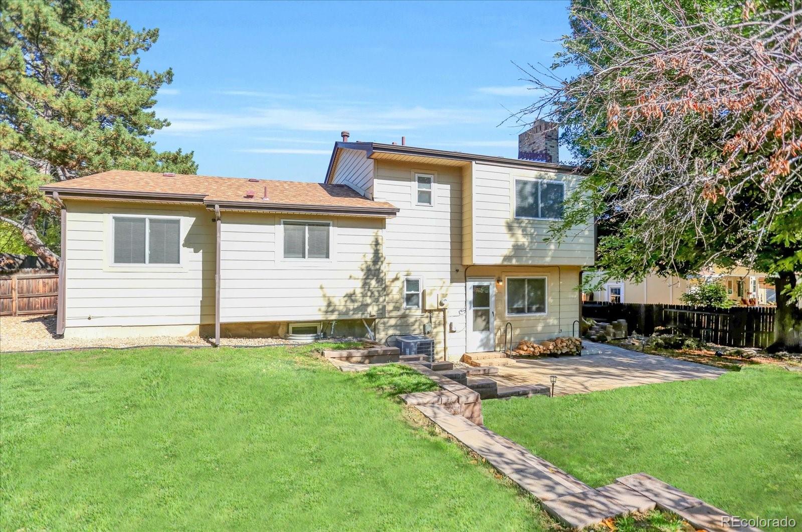 3754 South Walden Way Aurora, CO 80013 - Photo 31 of 32 a view of a house with a yard and sitting area