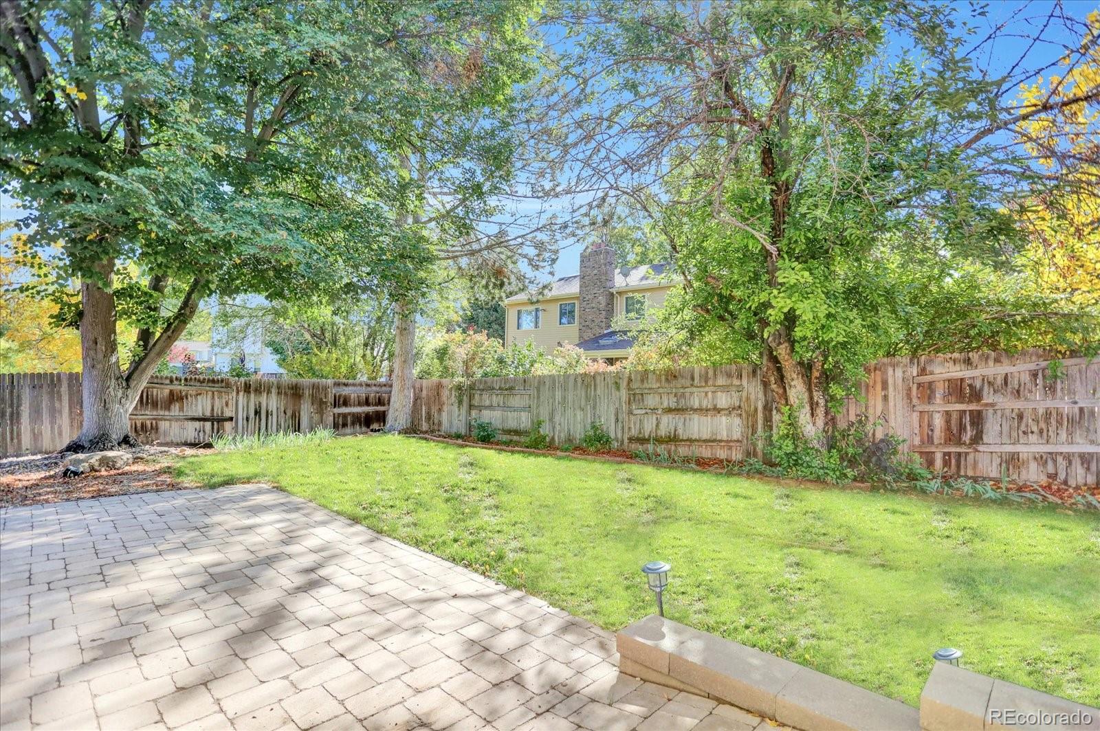 3754 South Walden Way Aurora, CO 80013 - Photo 32 of 32 a view of a yard with plants and trees