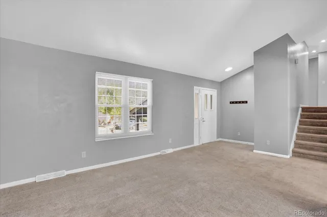 a view of an empty room with a window