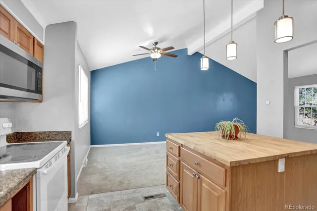 a kitchen with a sink a stove and microwave