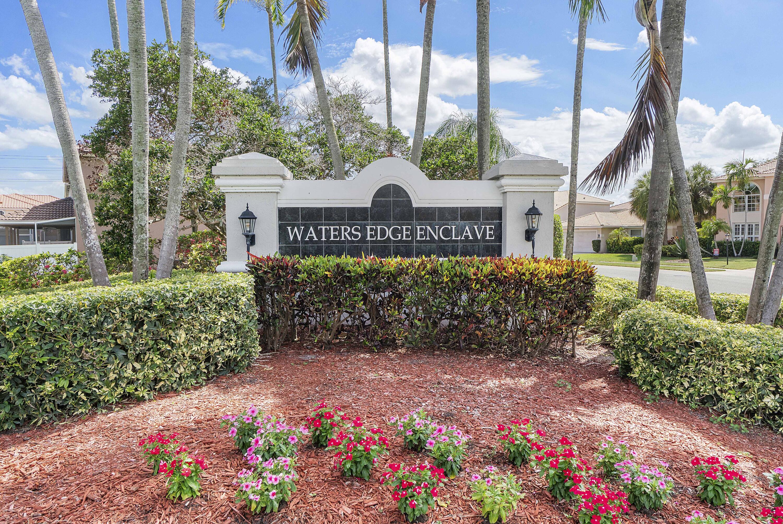 12328 St Simon Drive Boca Raton, FL 33428 - Photo 43 of 52 a view of sign board with buildings in the background