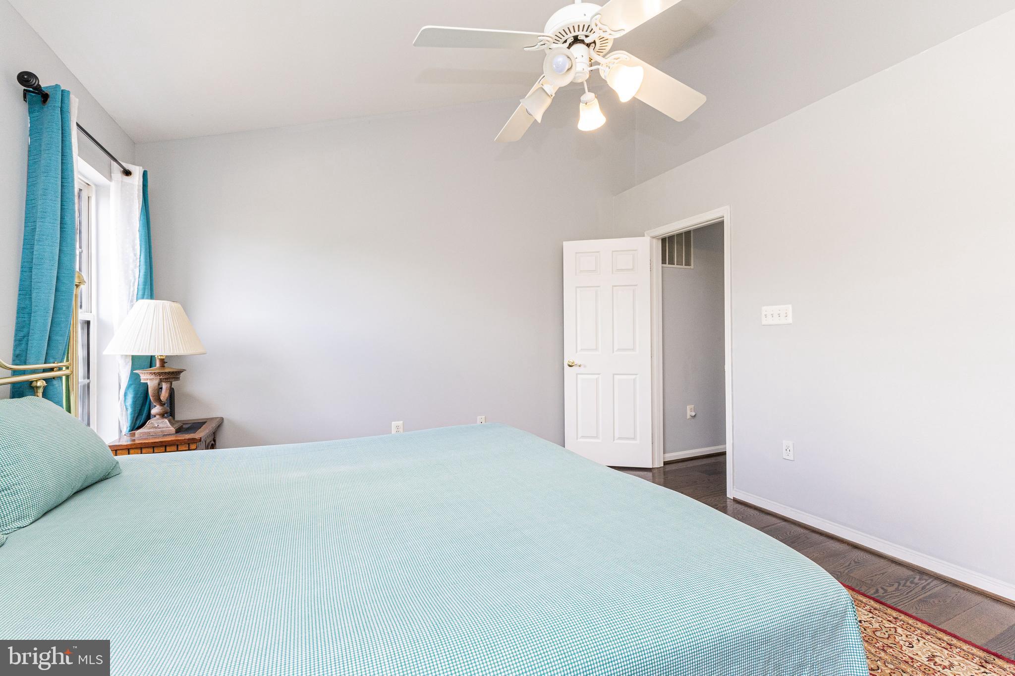 8226 Bates Road Lorton, VA 22079 - Photo 14 of 20 a bedroom with a bed and a chandelier