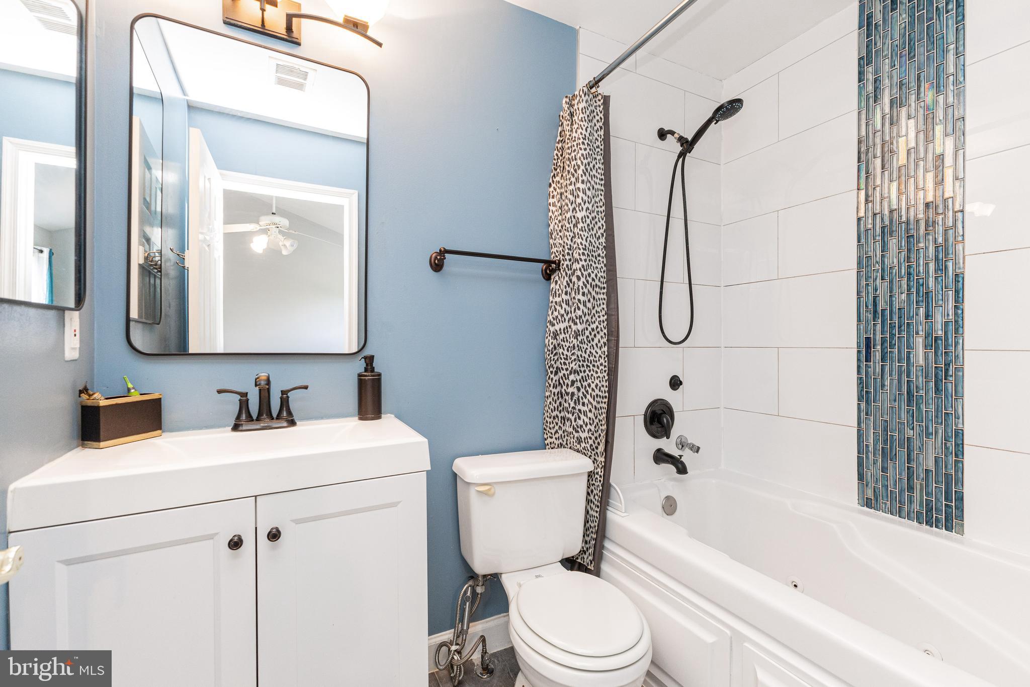 8226 Bates Road Lorton, VA 22079 - Photo 15 of 20 a bathroom with a sink toilet and shower
