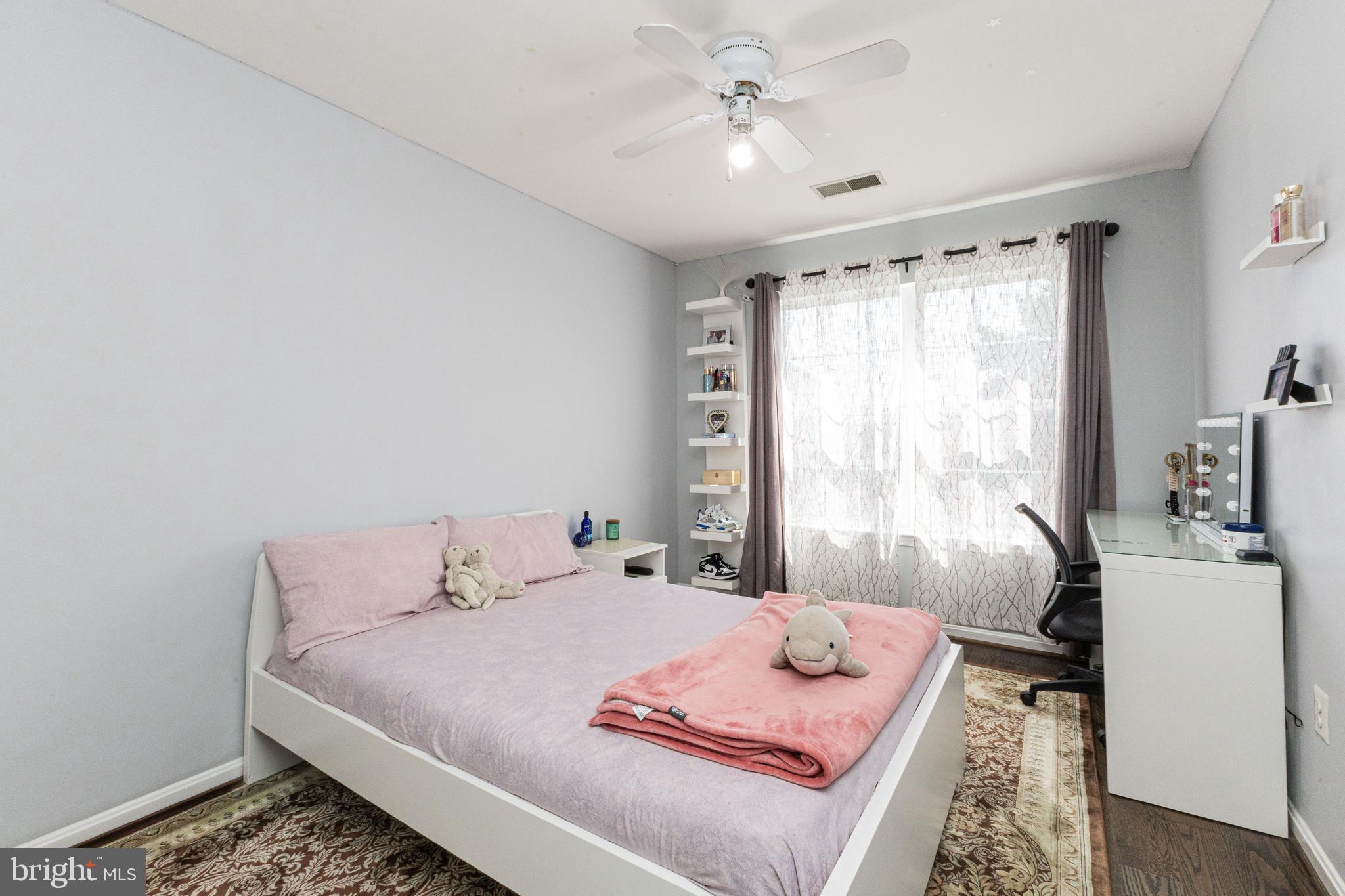 8226 Bates Road Lorton, VA 22079 - Photo 18 of 20 a bedroom with a bed and a chandelier