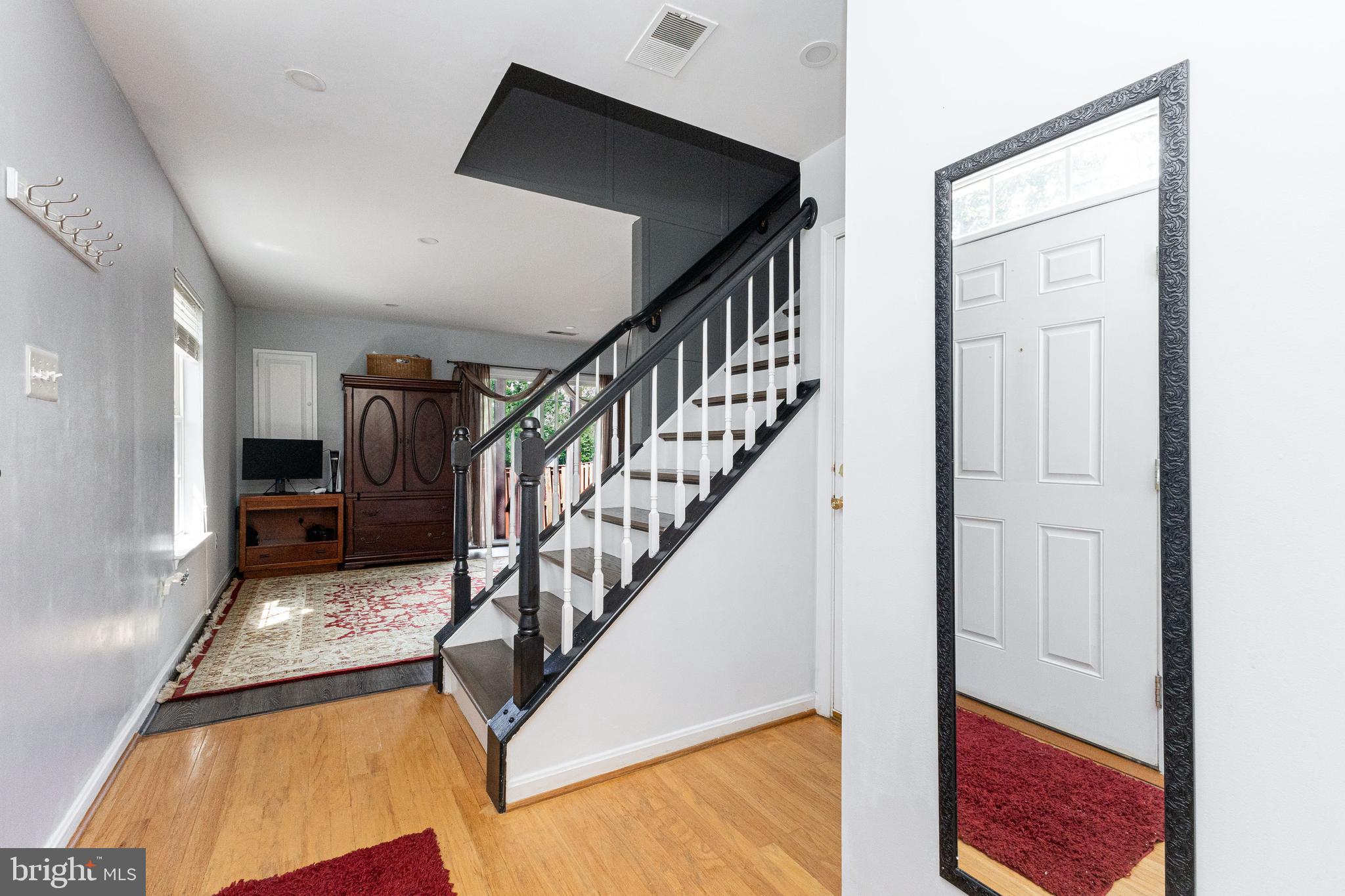 8226 Bates Road Lorton, VA 22079 - Photo 3 of 20 a view of entryway and hall with wooden floor