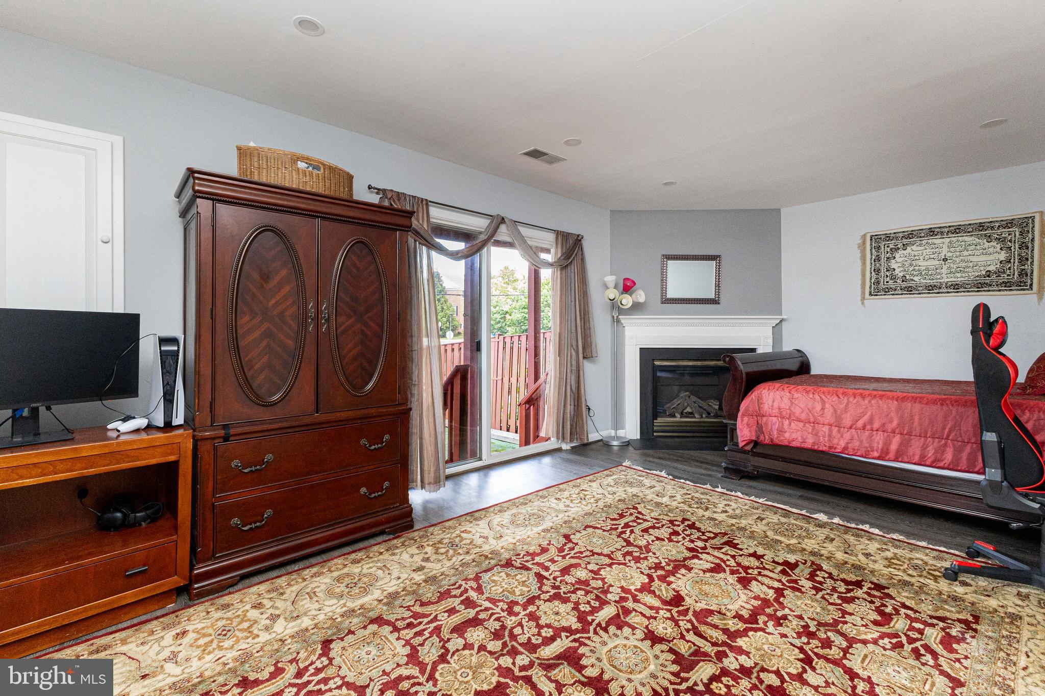 8226 Bates Road Lorton, VA 22079 - Photo 4 of 20 a bedroom with furniture and a flat screen tv