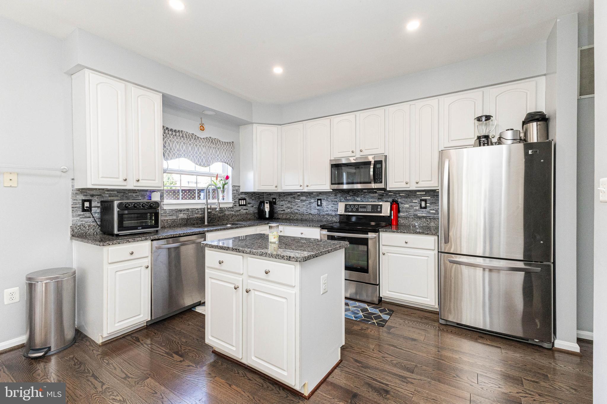 8226 Bates Road Lorton, VA 22079 - Photo 7 of 20 a kitchen with cabinets stainless steel appliances a sink and a window