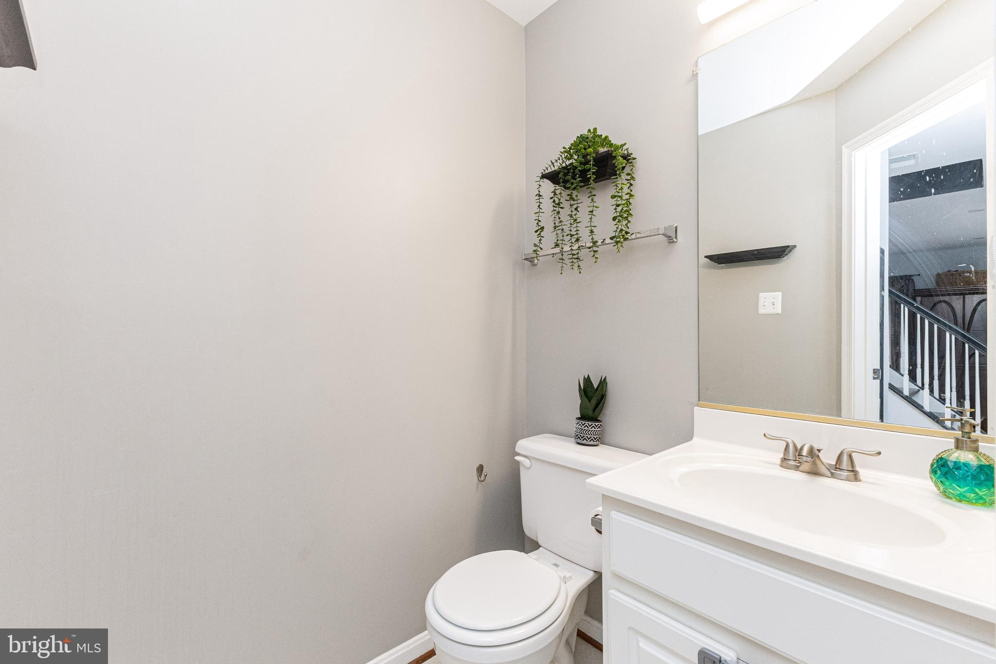 8226 Bates Road Lorton, VA 22079 - Photo 9 of 20 a bathroom with a toilet a sink and mirror